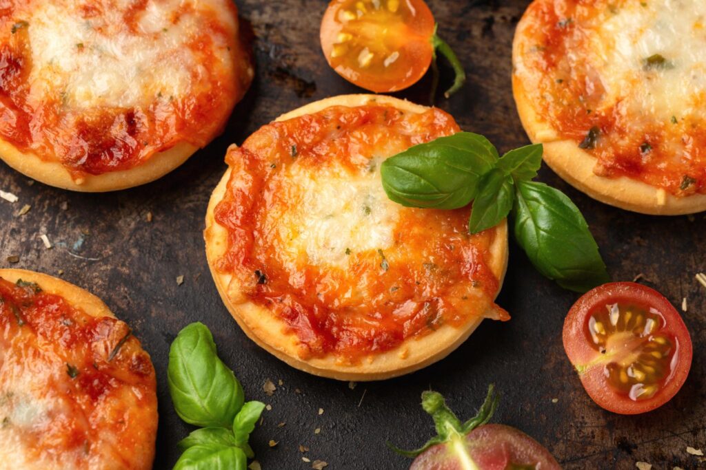 mini pizza topped with cherry tomatoes and melted cheese